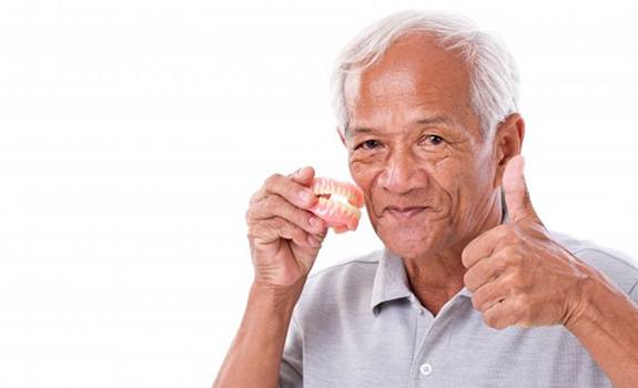 Man with dentures in Lakewood gives thumbs up.