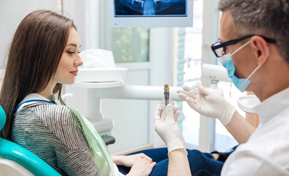 Dentist explaining all-on-4 dental implants to patient