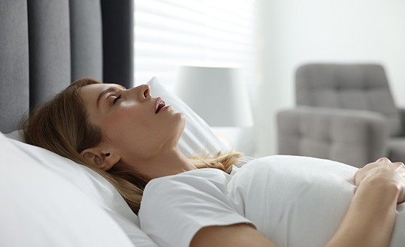 Woman snoring while sleeping on her back