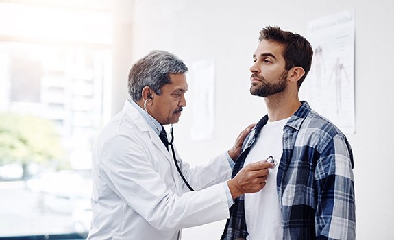 Man undergoing checkup with his primary care doctor