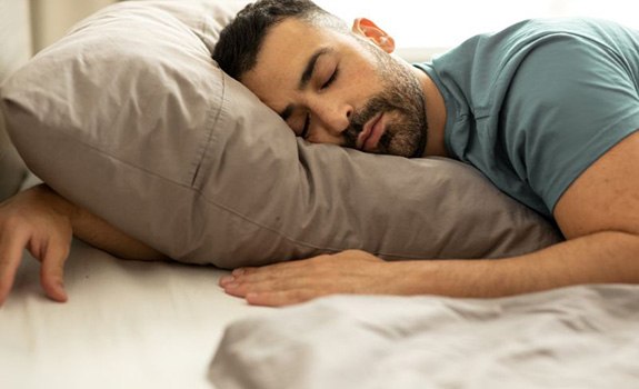 Man sleeping comfortably in bed