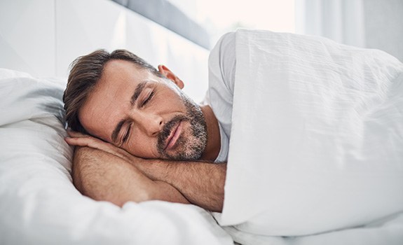 Man sleeping peacefully in comfy bed