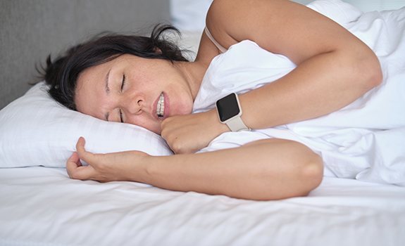 A woman clenching her jaw in her sleep