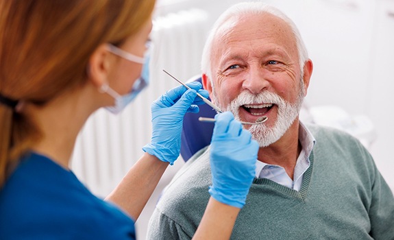 Man smiles at dentist