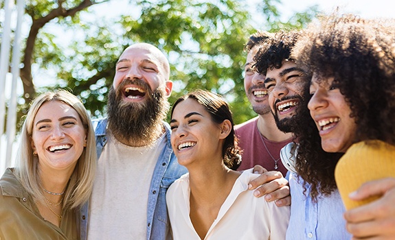 Invisalign patient in Dallas smiling with friends