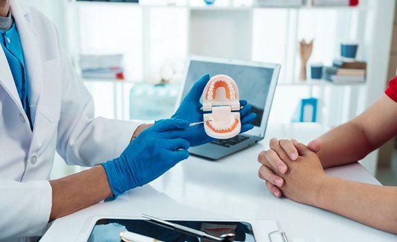 Patient and dentist sitting at desk during consultation